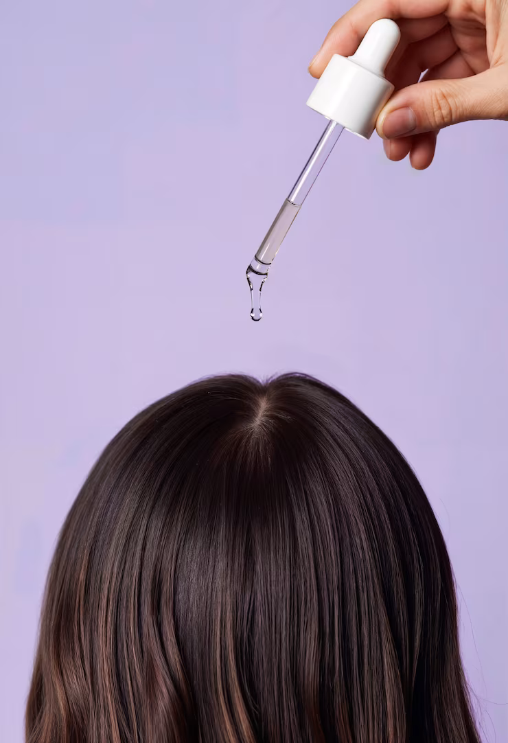 applying serum hair with dropper 23 2151968661