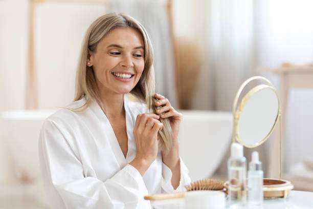 Hair oil. Beauty cosmetic. Pretty elegant woman hands applying professional