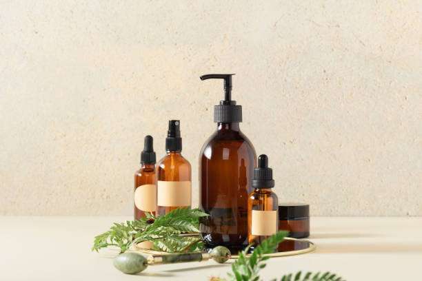 pouring hair oil on hand close up .