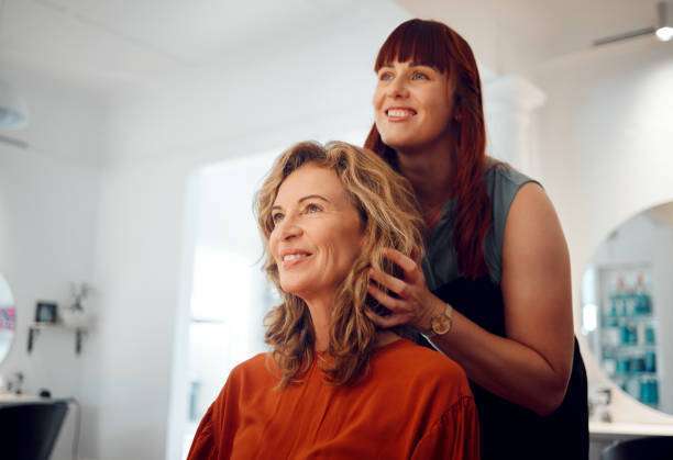A lady dripping hair oil with a pipette on her hair.