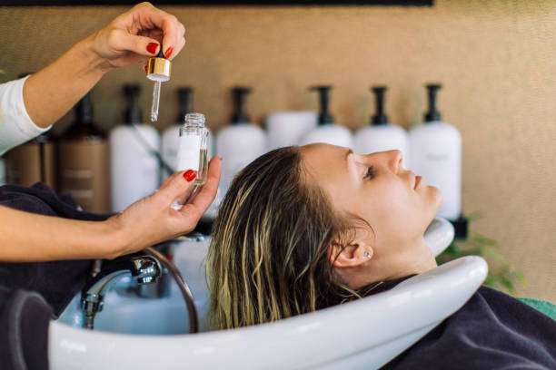 She is relaxing with her eyes closed. hair oil