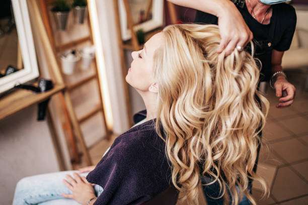 a beautiful hairstyle for a young adult woman after dyeing her hair and making highlights in a hair oil.